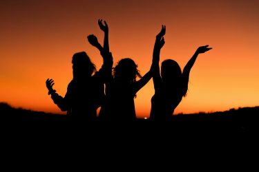 levi-guzman-zdSoe8za6Hs-unsplash(500_3 women_arms-raised_sunset)